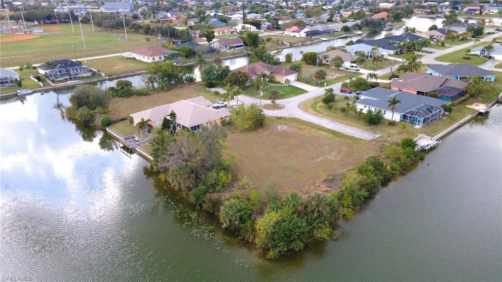 Image 4: View of property location with a nearby body of water and nearby suburban area