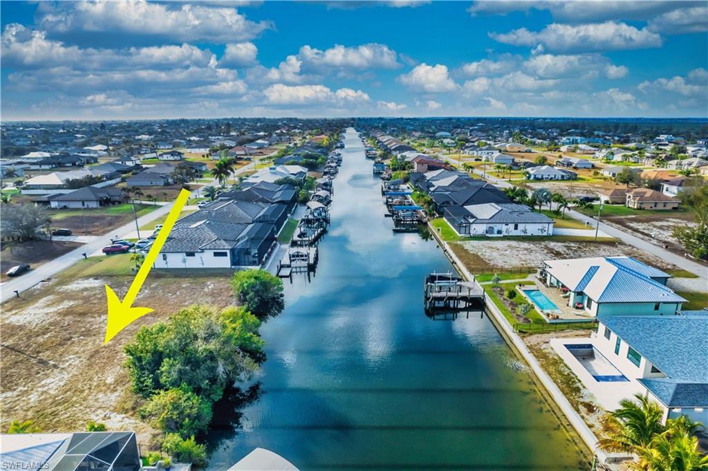 Image 1: Aerial view of residential area with a nearby body of water