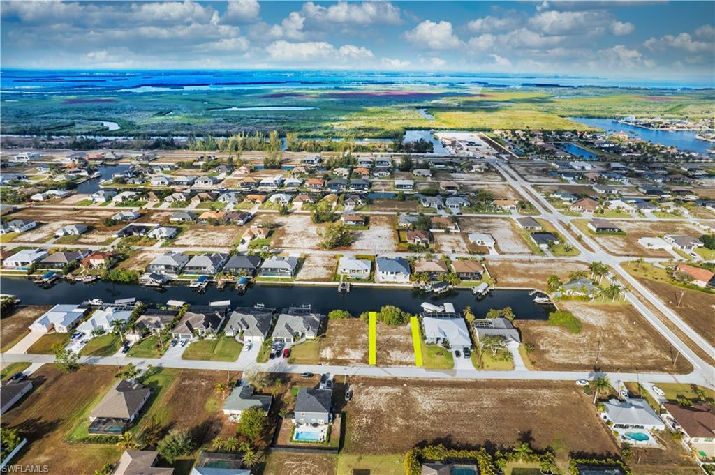 Image 2: Aerial view of property's location featuring nearby suburban area and a large body of water