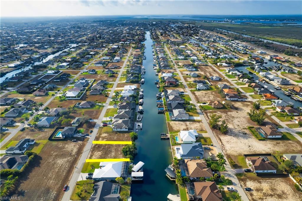 Image 3: View of property location with nearby suburban area and a large body of water