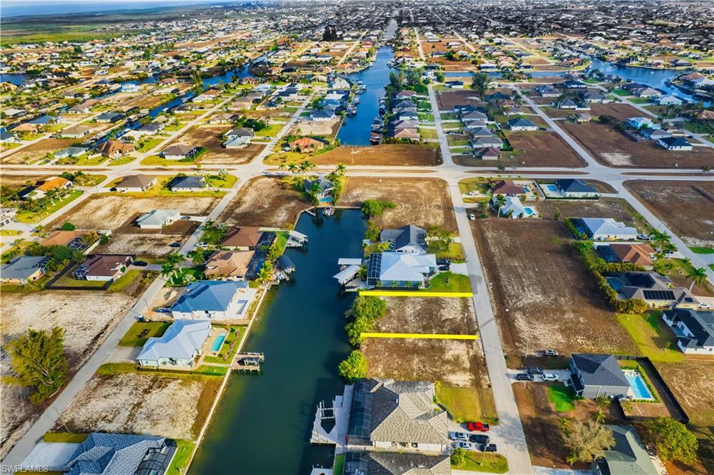 Image 4: Aerial perspective of suburban area featuring a nearby body of water
