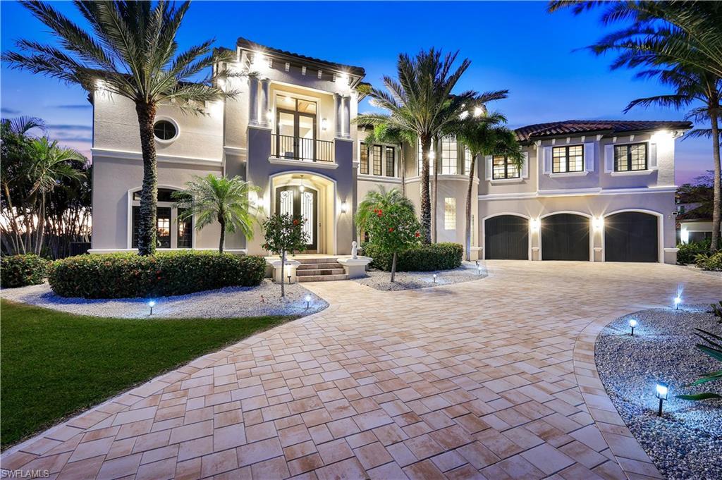 Image 1: Mediterranean / spanish house featuring french doors, decorative driveway, an attached garage, stucco siding, and a balcony