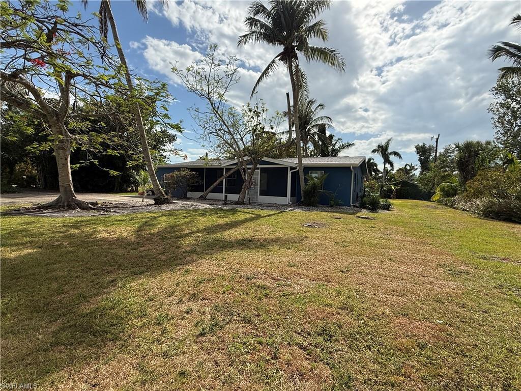Image 2: Front of property featuring a yard and a sunroom