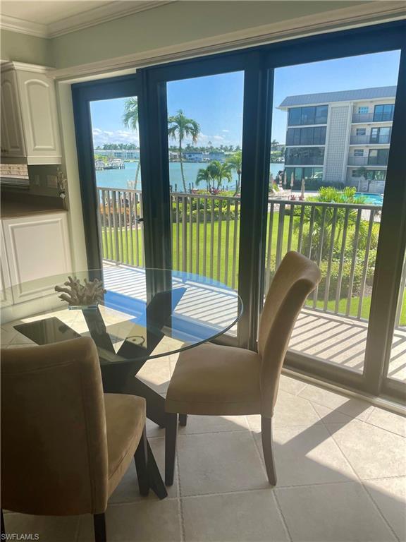 Image 3: Dining room featuring a water view,