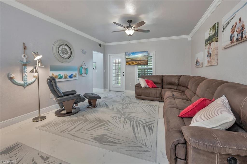 Image 3: Living area featuring crown molding and ceiling fan