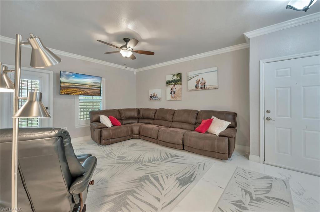 Image 4: Living area with crown molding and a ceiling fan