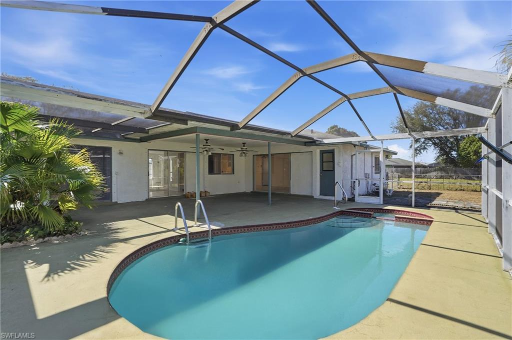 Image 1: Outdoor pool with an in-ground hot tub, a lanai, a sunroom, and a patio