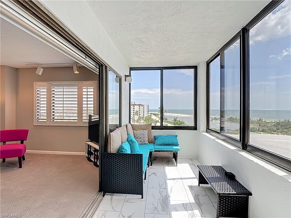 Image 4: Sunroom / solarium featuring marble finish floors, a water view, healthy amount of natural light, a textured ceiling, and a textured wall