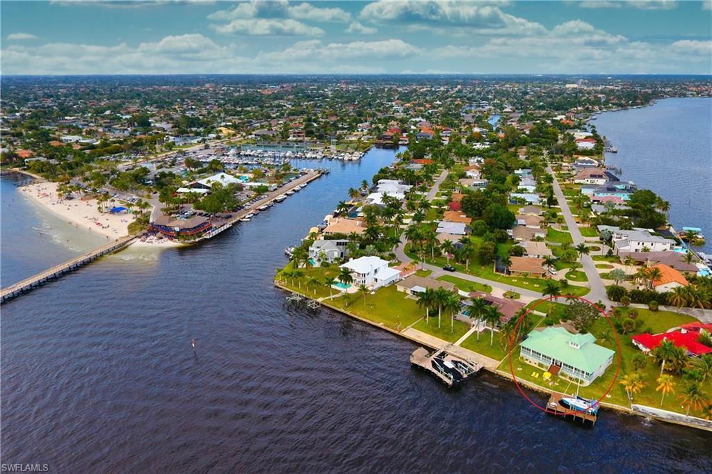 Image 2: Aerial view of residential area featuring a large body of water
