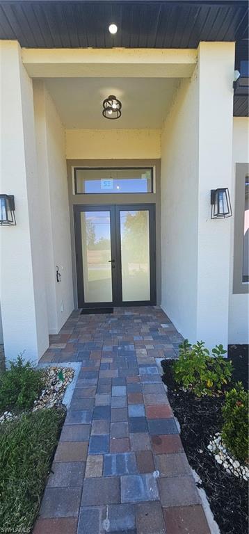 Image 4: Prairie-style home featuring stucco siding, decorative driveway, and a front yard
