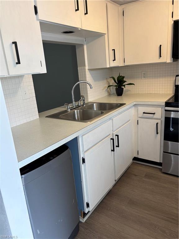 Image 2: Kitchen featuring range, light countertops, dishwasher, and backsplash