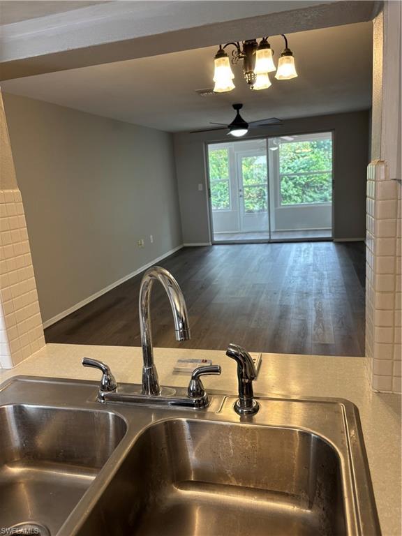 Image 4: Kitchen view of a sink and wood finished floors