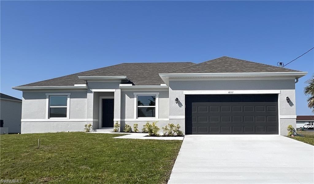 Image 1: Prairie-style house with a front yard, stucco siding, concrete driveway, an attached garage, and roof with shingles