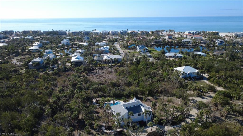 Image 4: Aerial perspective of suburban area featuring a large body of water