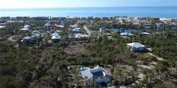 Image 4: Aerial perspective of suburban area featuring a large body of water