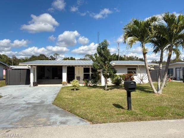 Image 2: Ranch-style house featuring a front yard and concrete driveway