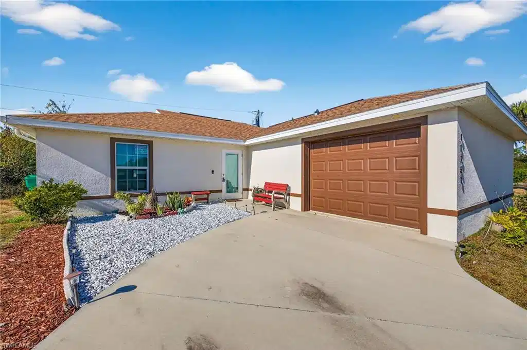 Image 1: Ranch-style house featuring driveway, stucco siding, an attached garage, and roof with shingles