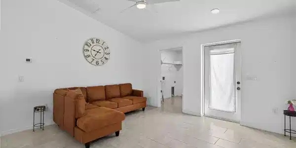 Image 4: Living area with lofted ceiling and a ceiling fan