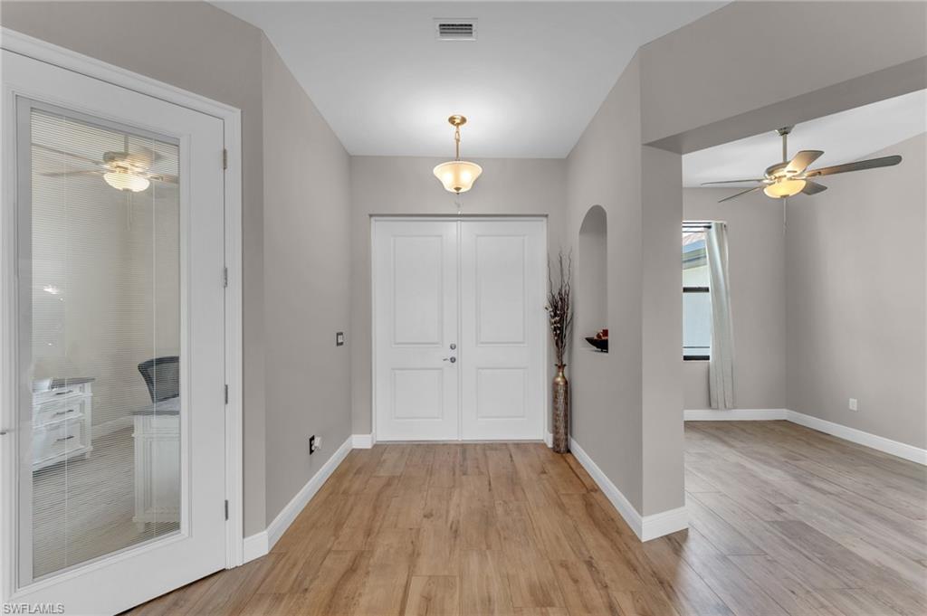Image 3: Foyer with a ceiling fan, light wood-type flooring, and arched walkways