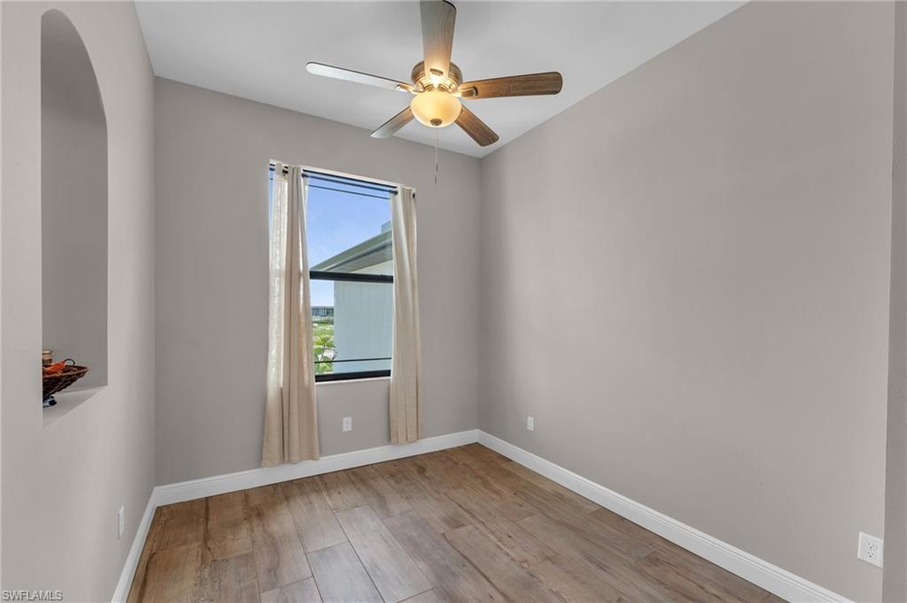 Image 4: Empty room with light wood-style flooring and ceiling fan