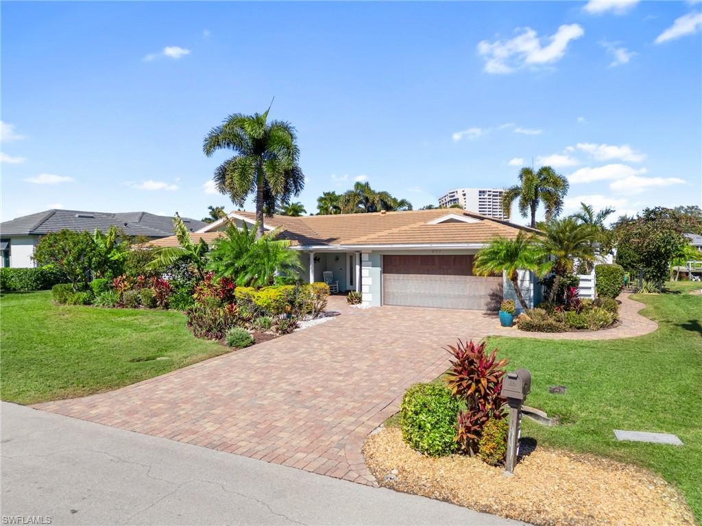Image 2: Ranch-style house with a front lawn, driveway, and a garage
