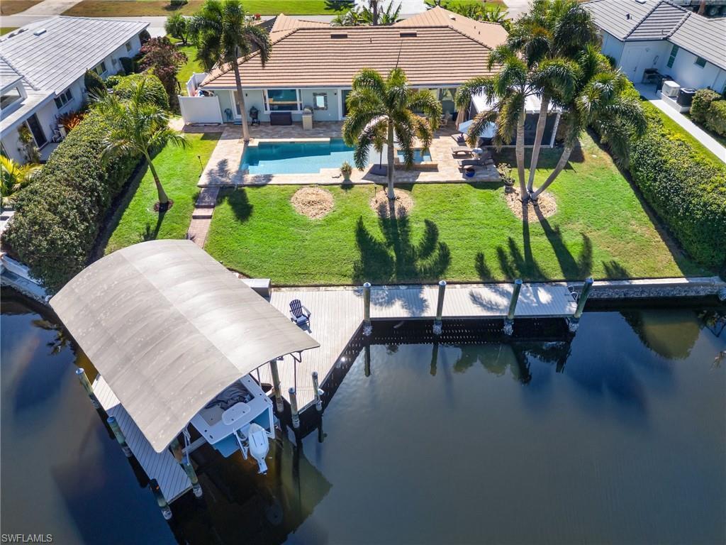 Image 4: Aerial view of property and surrounding area featuring a nearby body of water