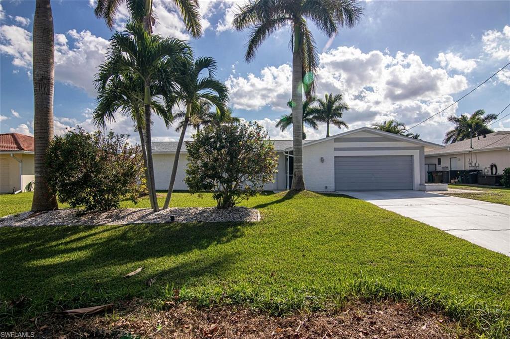 Image 3: Ranch-style home with a front lawn, driveway, and an attached garage