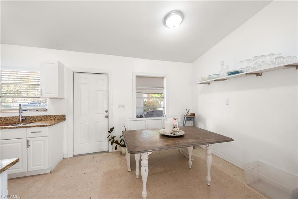 Image 4: Dining area featuring vaulted ceiling