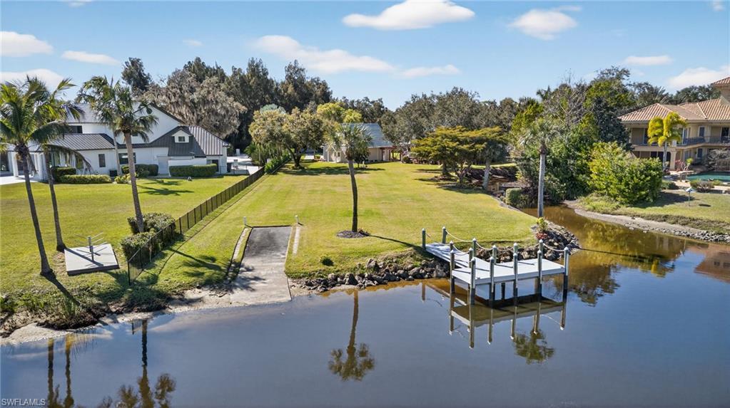 Image 3: Dock area featuring a yard and a river view