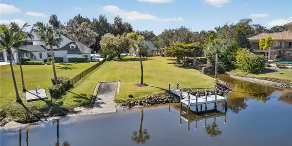 Image 3: Dock area featuring a yard and a river view