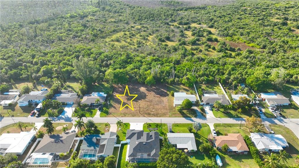 Image 4: Aerial view of residential area with a forest