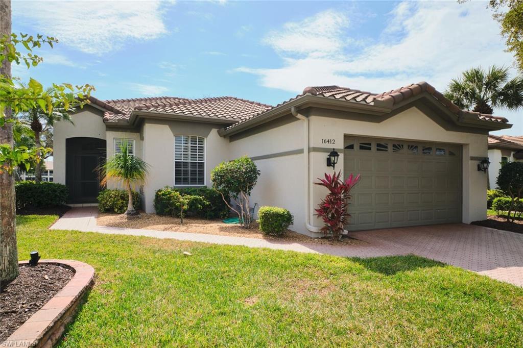 Image 1: Mediterranean / spanish house featuring a front lawn, a garage, stucco siding, decorative driveway, and a tiled roof