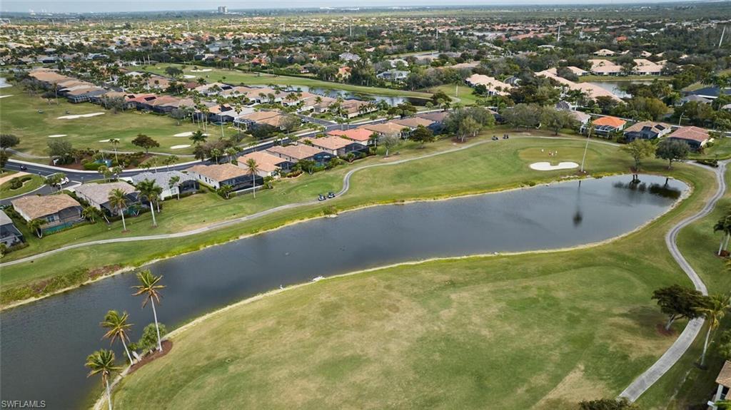 Image 2: Aerial overview of property's location featuring a local golf course, nearby suburban area, and a nearby body of water