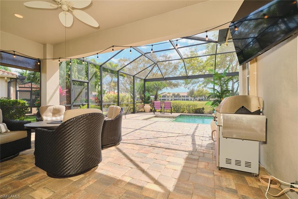 Image 3: View of patio with an outdoor pool, a ceiling fan, a lanai, and a sunroom
