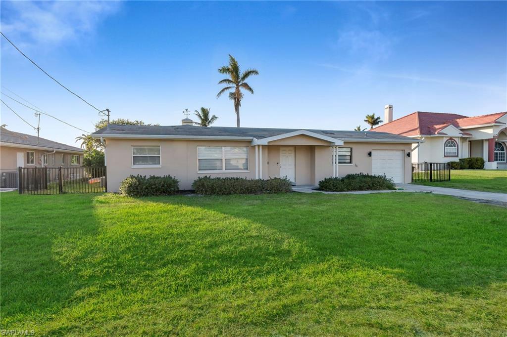 Image 1: Ranch-style house featuring a front yard and a garage