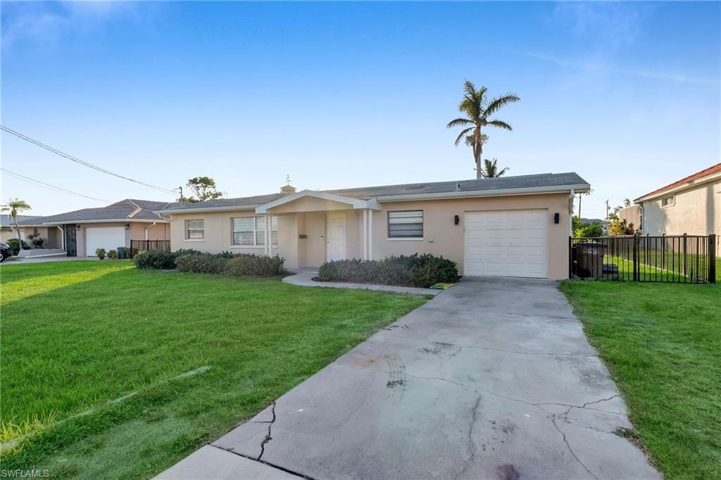 Image 3: Ranch-style home with a front yard and a garage