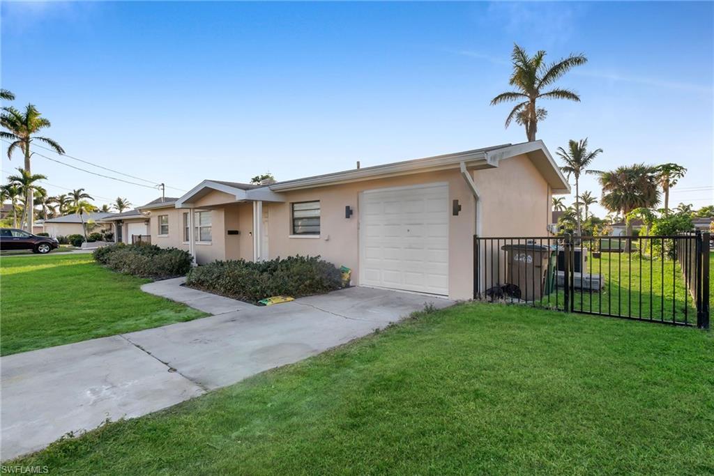 Image 4: Ranch-style house with a front yard and a garage