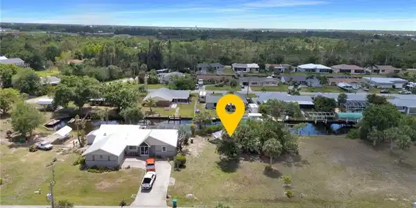 Image 2: Birds eye view of property featuring a forest view, a residential view, and a water view
