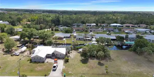 Image 4: Bird's eye view featuring a residential view, a wooded view, and a water view