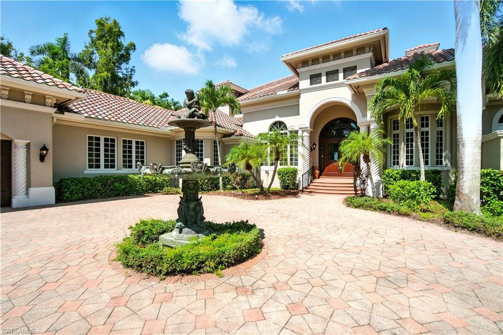 Image 4: View of front facade featuring stucco siding and a tiled roof