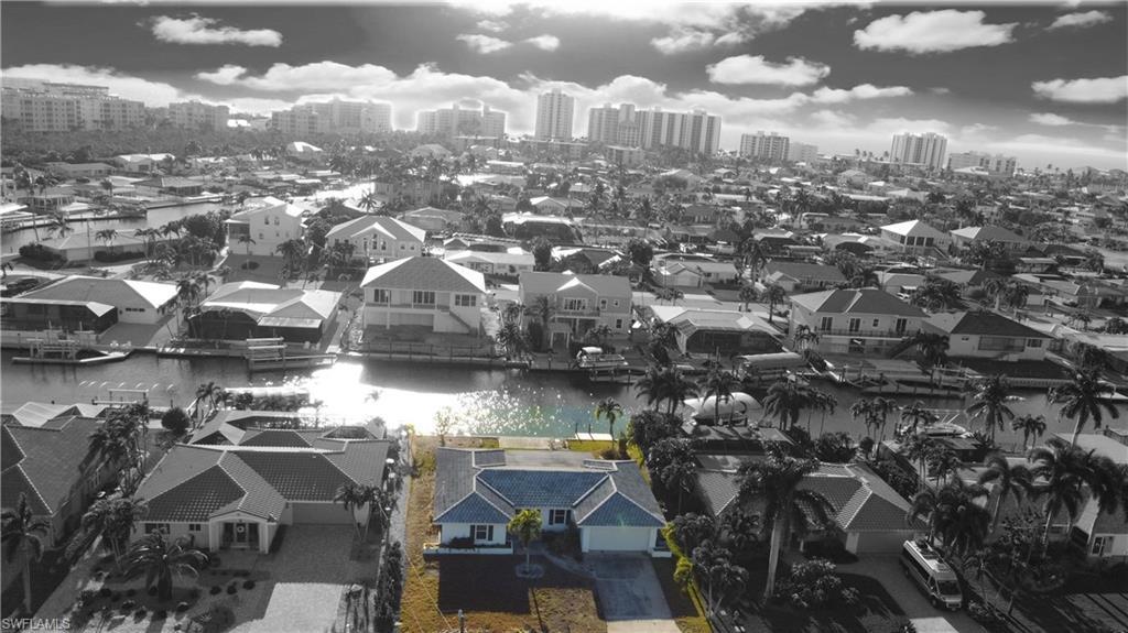 Image 3: View of urban area featuring a nearby body of water and nearby suburban area