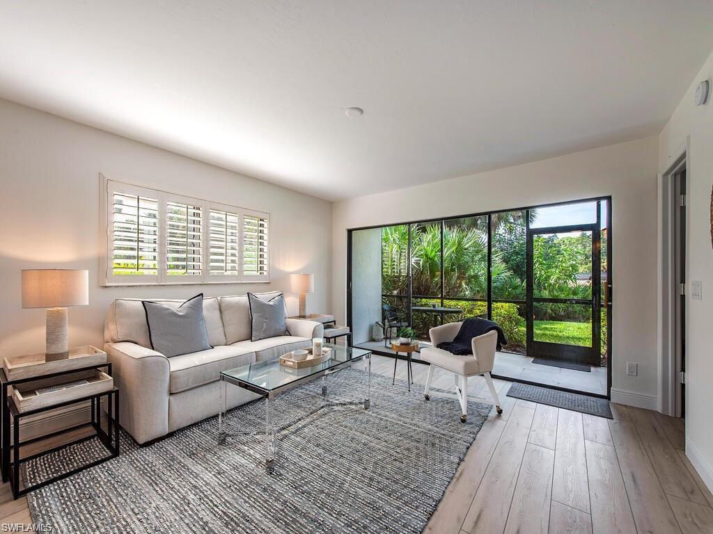 Image 3: Living area featuring light wood finished floors and baseboards