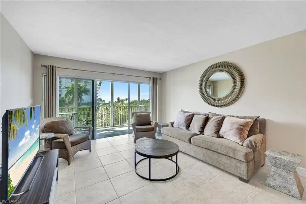 Image 1: Living area featuring light tile patterned floors and a textured ceiling
