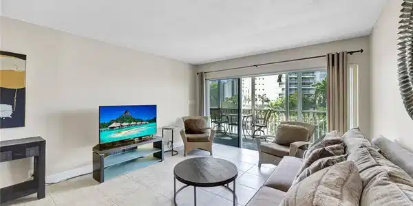 Image 2: Living area with tile patterned floors and a textured ceiling