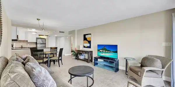 Image 3: Living area with baseboards and light tile patterned floors