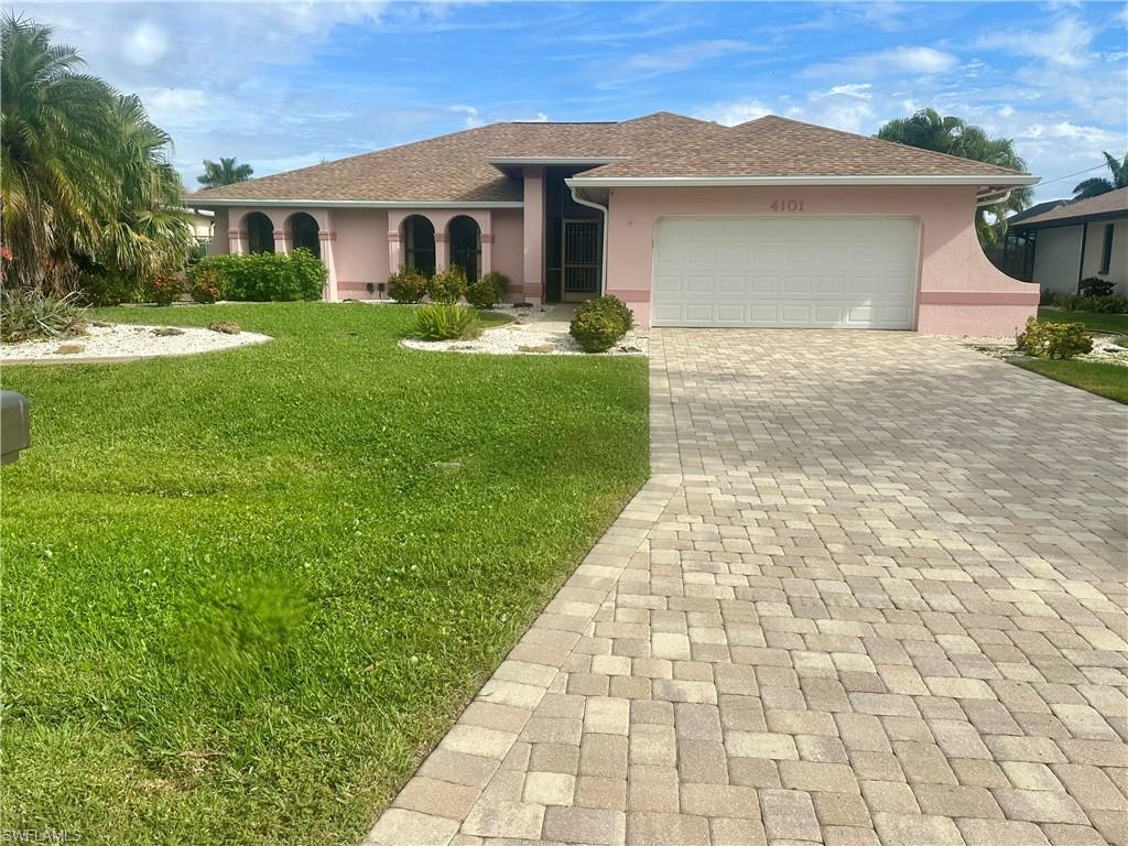 Image 1: View of front of home featuring stucco siding, decorative driveway, a front yard, a garage, and roof with shingles