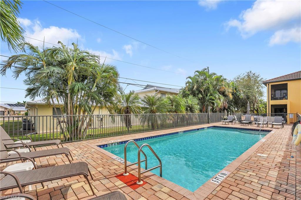 Image 2: Community pool with a patio area