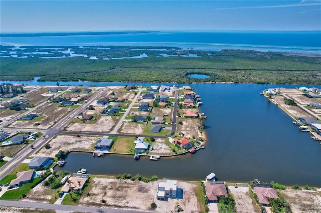 Image 3: Aerial perspective of suburban area with a large body of water