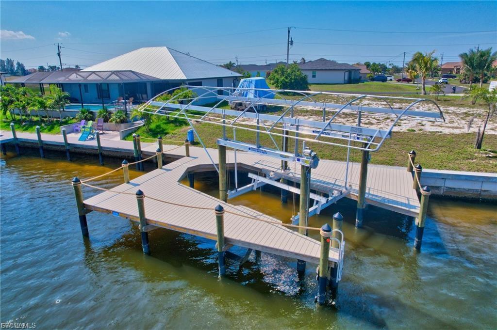 Image 4: Dock area with boat lift and a water view