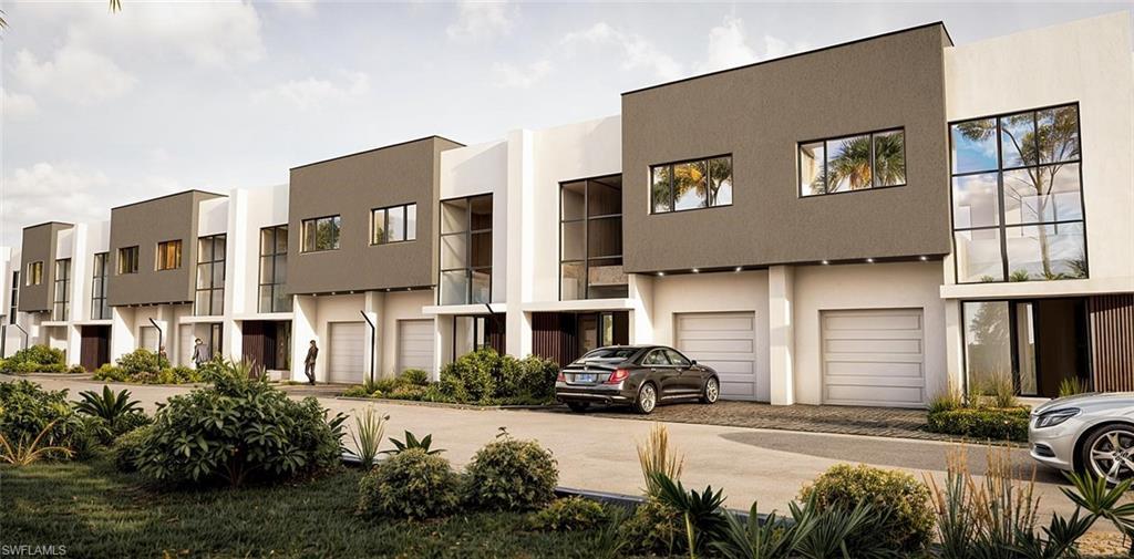 Image 2: View of property with decorative driveway and an attached garage